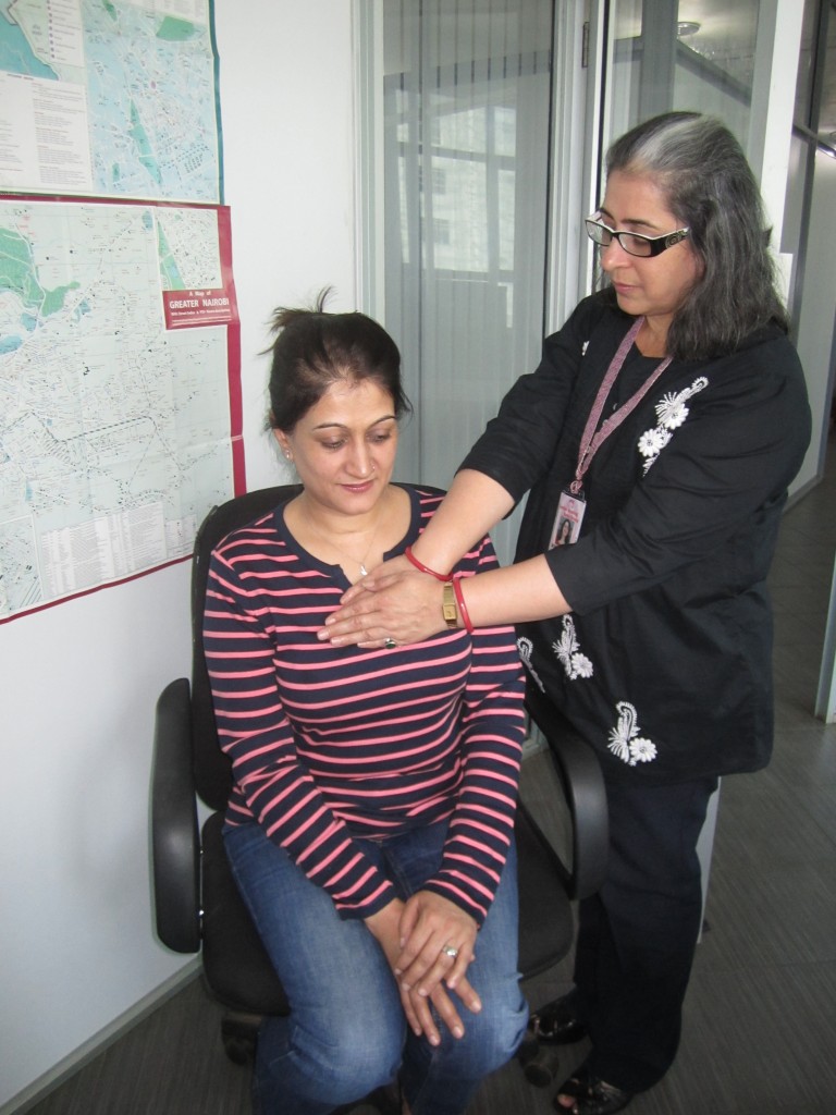 Monica gives Reiki healing to Sharmila